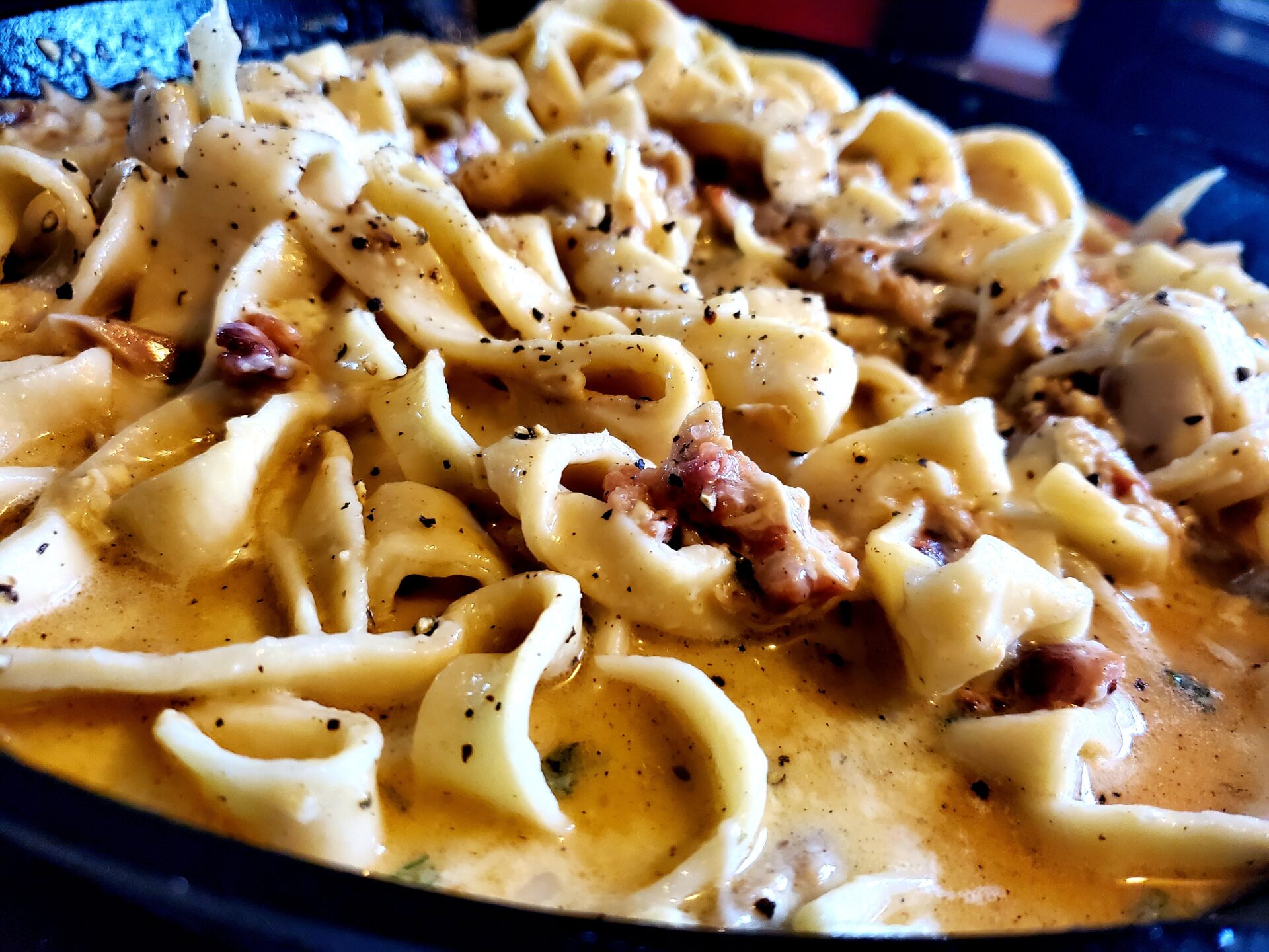 chicken carbonara with homemade egg noodles in a cast iron skillet