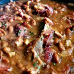 a crockpot of pinto beans and ham hocks