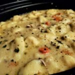 A picture of chicken and dumplings in a crockpot.