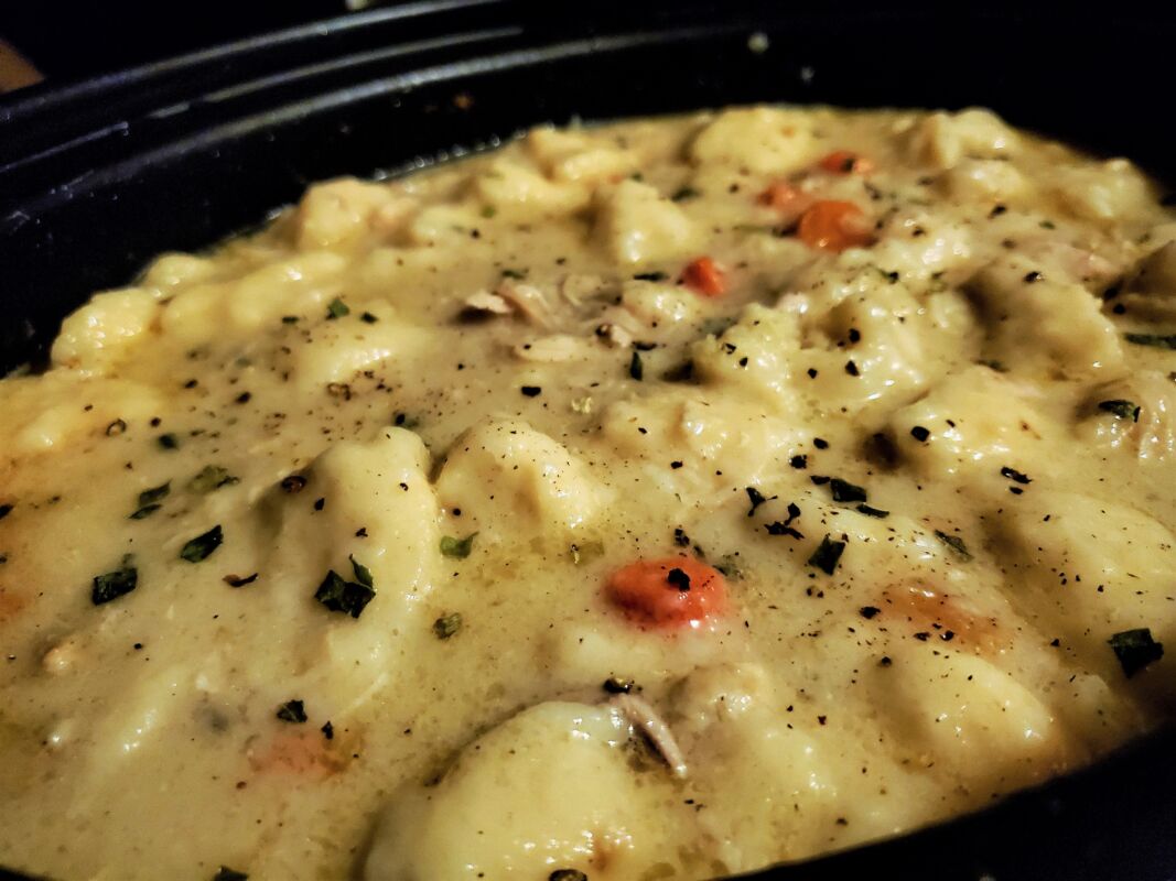 A picture of chicken and dumplings in a crockpot.