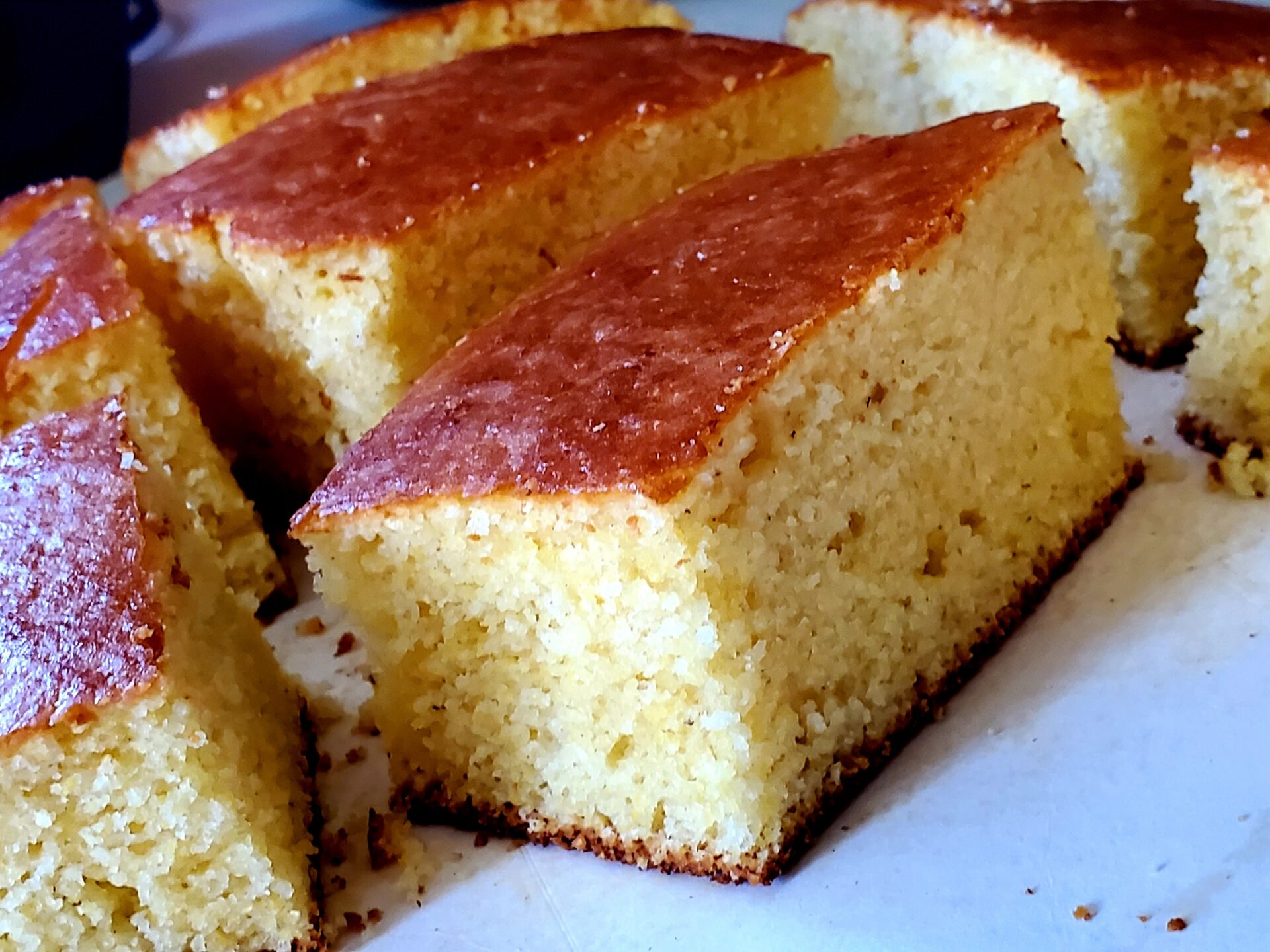 A picture of freshly baked cornbread on a cutting board.