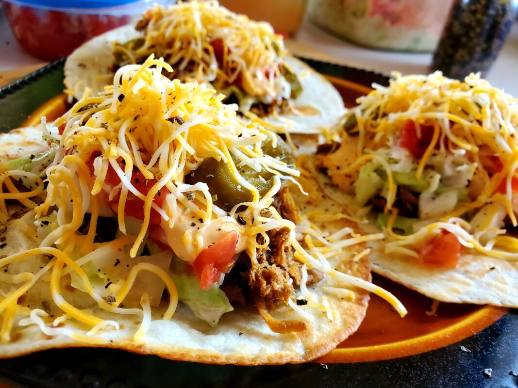 A picture of pulled pork and white slaw hillbilly tacos.