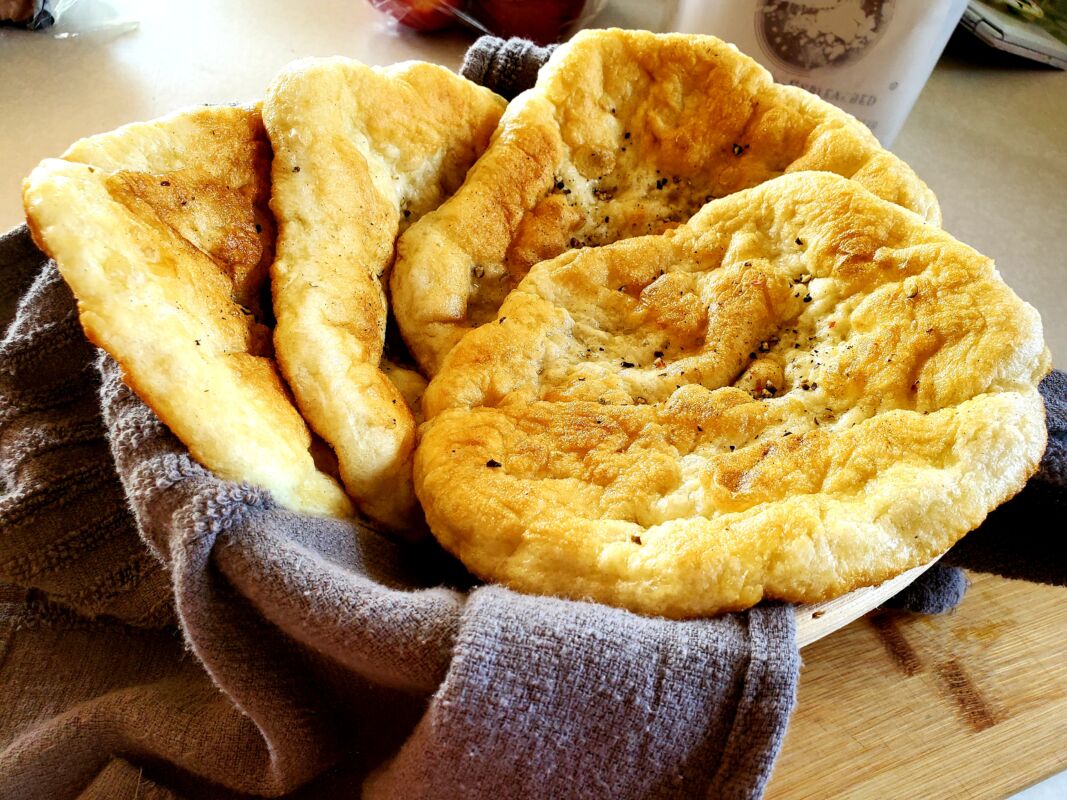 A picture of cooked fry bread in a basket.